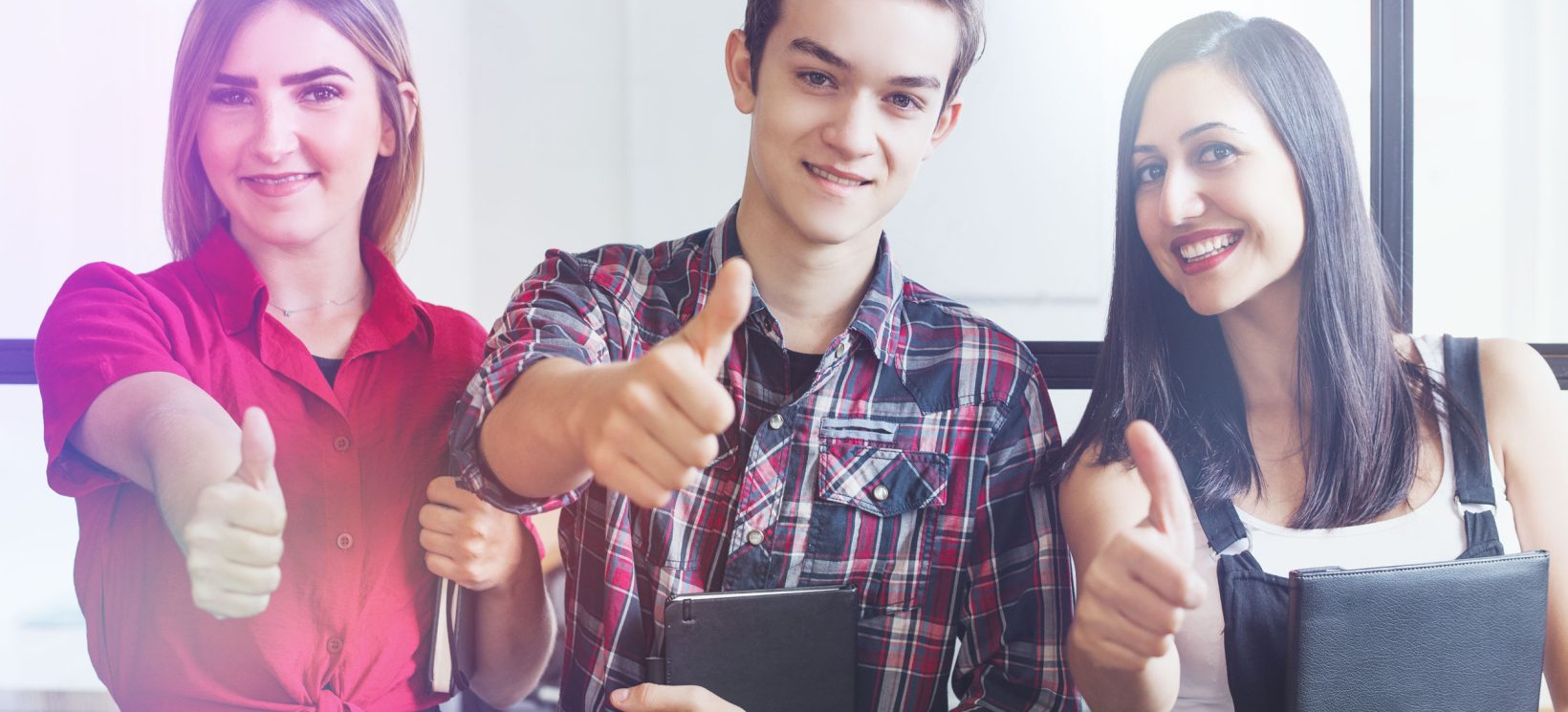 portrait-successful-young-students-showing-thumbs-up